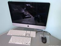 Silver Apple iMac with 22-inch display and accessories on desk