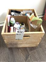 Wooden crate containing art paints, brushes, and supplies