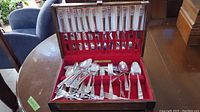 Full wooden box containing the flatware set