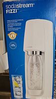 Box front showing SodaStream Fizzi branding and product image with bubbles in the bottle
