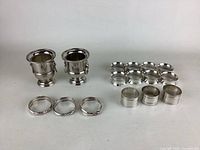 Two silverplated mini ice buckets and ten napkin rings shown on white background, noted some tarnishing.