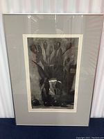 Framed black and white print showing floral arrangement with fruit, overall view of the artwork and frame.