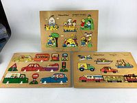 Three wooden puzzles laid out showing the nursery rhymes puzzle on top and the two vehicles puzzles below it.