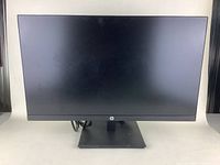 Front view of HP P44 monitor with black screen and base, showing overall good condition and slim bezel