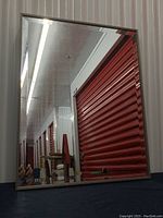 Front view of the beveled mirror showing reflective surface and frame.