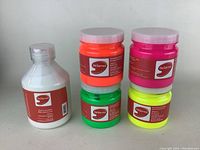 Five jars of acrylic paint from De Serres including fluorescent orange, pink, yellow, green, and glow in the dark white