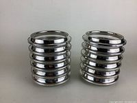 Stacked coasters showing polished sterling silver rims with beaded edges.