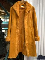 Full-length front view of coat on hanger showing exterior