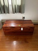 Front view of solid wood vintage chest showing wood grain and top surface.