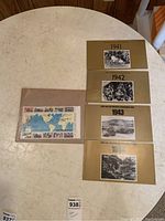 Five WWII commemorative stamp sets from 1941 to 1945 with gold colored backing and historic black and white photos for each year. One additional colorful world map themed stamp sheet.