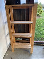 Front view of the pine shelving unit showing three shelves and natural wood finish.