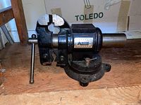 Side view of the Alltrade Professional vise showing the handle and clamping jaws with usage wear.