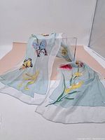 Full view of the scarf draped to show print and fabric