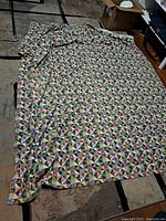 Full view of the quilt laid flat showing overall geometric triangular patchwork design