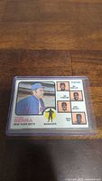 Front side of 1973 Yogi Berra baseball card showing Yogi Berra as Mets manager and photos of coaches