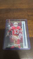 Brock Purdy rookie football trading card front view in protective sleeve.