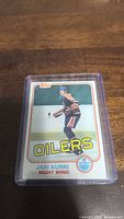 Photo of Jari Kurri rookie hockey card in plastic protective case showing player image, team, and position.