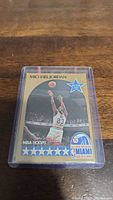 Close-up image of Michael Jordan NBA Hoops basketball card from 1990 All-Star Weekend in Miami enclosed in a protective plastic case, showing the card's front with Jordan's image and related logos