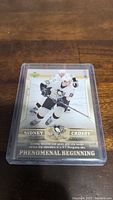Photo of Sidney Crosby rookie hockey card in a protective case showing front side with image and text details.