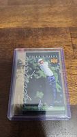 Tiger Woods rookie card in clear protective plastic case, featuring Tiger Woods swinging a golf club, from Upper Deck's Tiger's Tales series.