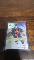 Front view of Tim Stutzle rookie hockey card in protective case with numbering 244/299.