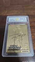 Front view of 2000 Fleer Ultra 23KT Gold Tom Brady rookie card graded WCG 10 Gem Mint in protective plastic case.