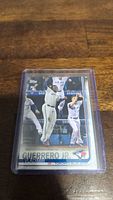 Photo of Vladimir Guerrero Jr rookie baseball card in a clear plastic protective sleeve, showing front view of card with player image and details.