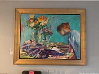 Frontal view of framed colorful painting showing person and floral arrangement