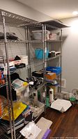 Full view of two HDX wire utility shelving units loaded with miscellaneous items
