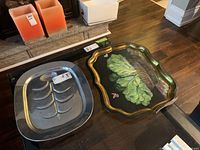 Photo showing both trays side by side on a glass table with a fireplace in the background.