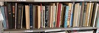 Shelf of assorted art books, various titles and condition, including large hardcover volumes and smaller notebooks.