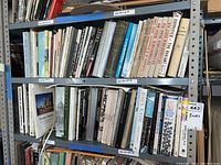 Two-tier metal shelf filled with assorted art, architecture and home improvement books