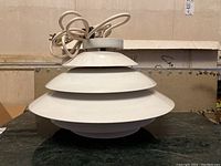 Front view of the white tiered metal shade