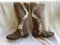 Side view of taupe suede boot showing fur trim detail and wedge heel