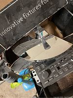 Two modern single-handle chrome faucets in original packaging with reflective chrome finish and lever handles.