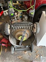 Overhead view showing mower deck, cutting blade and wheels