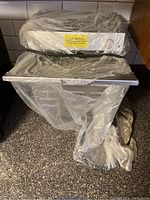 Front angle view of Somerset shrimp deveiner machine wrapped in plastic on countertop