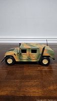 Side view of 1/18 scale Humvee model showing camouflage paint and exterior details