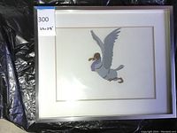 Front view of the framed Disney animation cel showing the flying seagull with a purple scarf