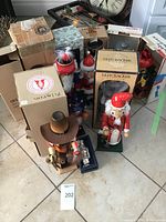 Overview photo showing all nutcracker figures arranged with some boxes visible in the background.