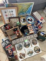 Wide view of lot showing patriotic Americana collection including nutcracker soldiers, rooster plates, books, ceramic tiles, and decorative items
