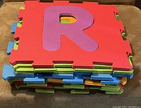Stack of 10 interlocking foam alphabet mats with visible letter R on top