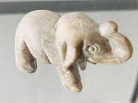 Single stone elephant figurine photographed showing side and front details