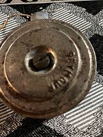 Top view of round metal chalk holder showing the stamped brand 'SEYMOUR'.