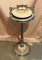 Full view of the vintage metal ashtray stand with a ceramic ashtray insert on top.