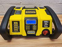 Front view of Stanley FatMax jumpstarter and compressor showing digital display, USB ports, and control buttons.