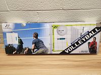 Box front and side showing Eastpoint volleyball set with illustrations of people playing volleyball outdoors. Box includes net, poles, and volleyball ball indicated.