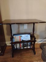 Photo of solid wood end table with magazine holder underneath.