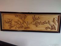 Framed rectangular wood relief carving of birds on cherry tree branches mounted on wall
