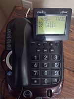 Front view of the black Clarity Alto Plus corded phone showing digital display and handset.